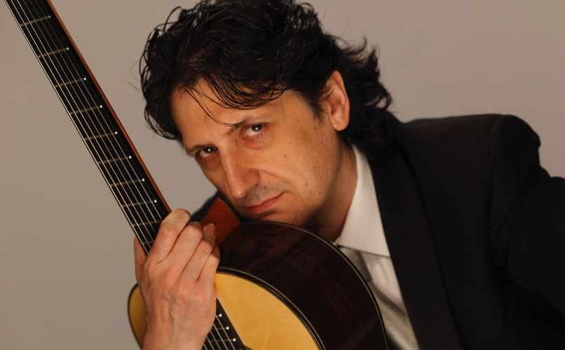 Portrait of guitarist Juan Cañizares with his guitar